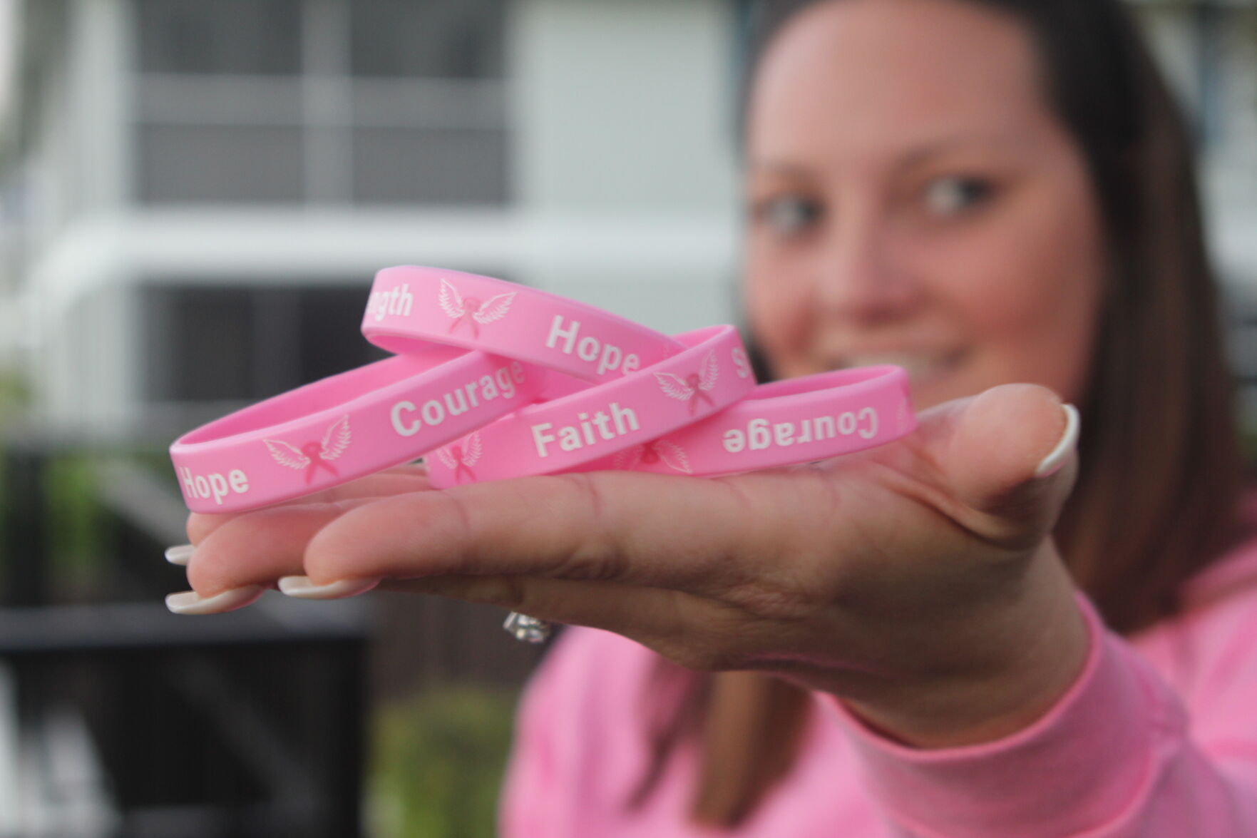 Woman Fights 3. Survivor Lauren Ross displays familiar symbols of hope and determination..jpg